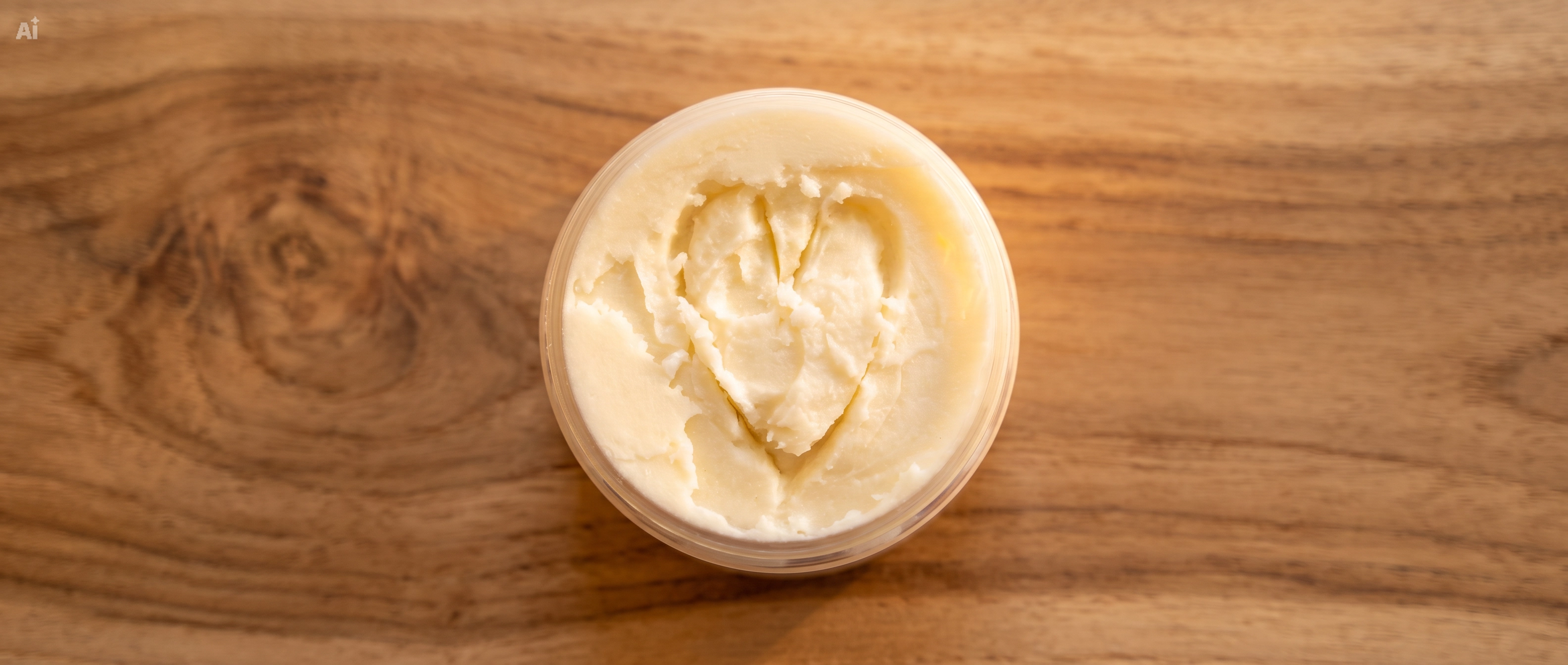 Whipped body butter with a heart traced into its surface
