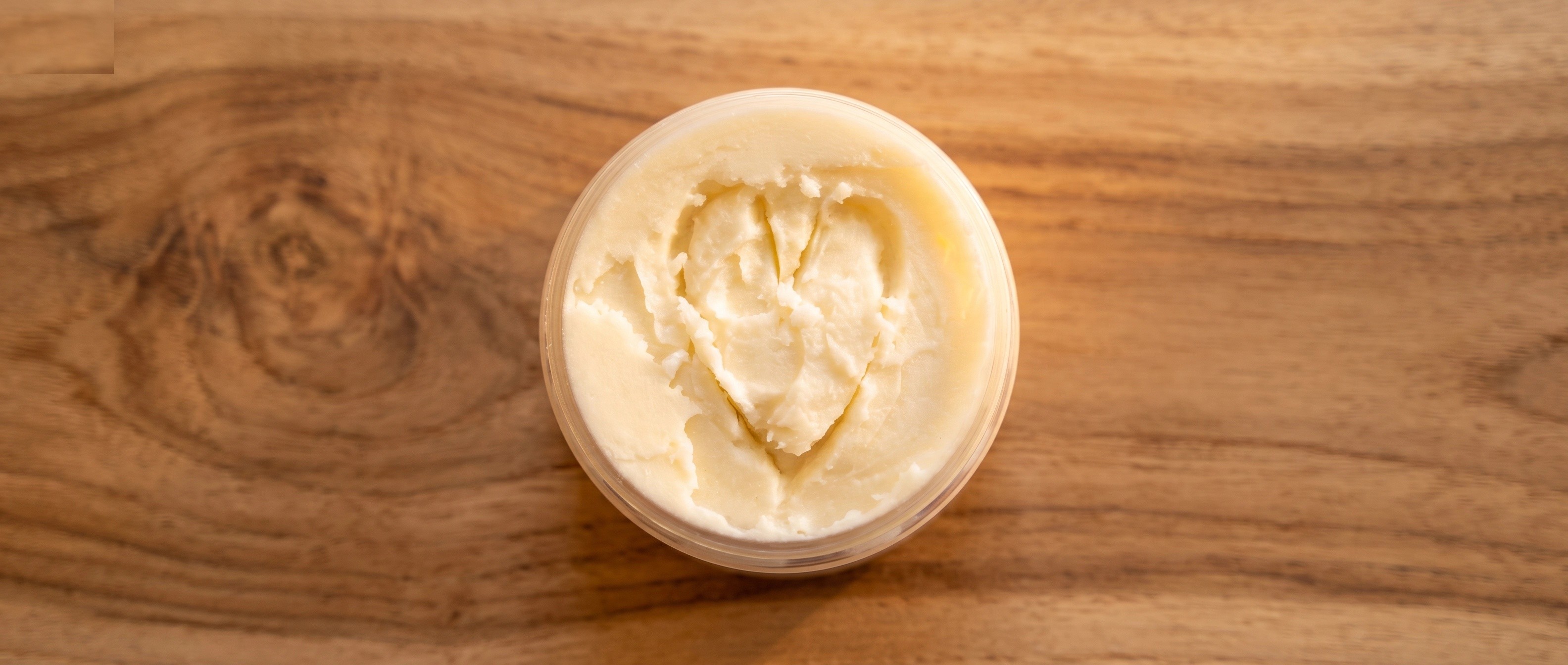 Whipped body butter with a heart traced into its surface